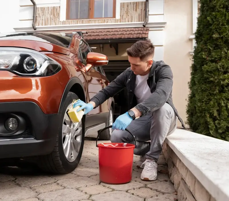Lavage auto à domicile Arbonne-la-Forêt : professionnel intervenant sur un véhicule